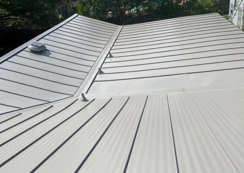 Solar attic fan installed on a metal roof for Roof Ventilation in Frankstown